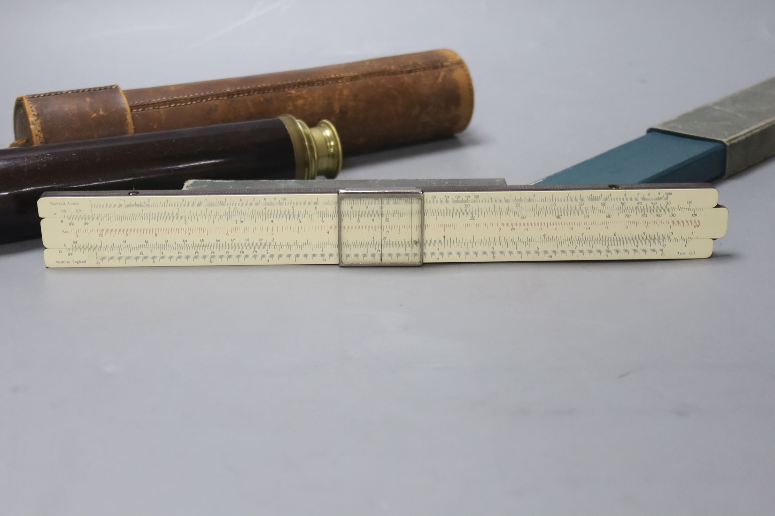 An early 20th century three drawer telescope by Lennie, Edinburgh, in leather case, and a cased slide rule